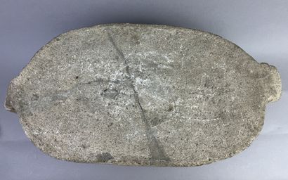 Metate. Corn grinding table in the shape...