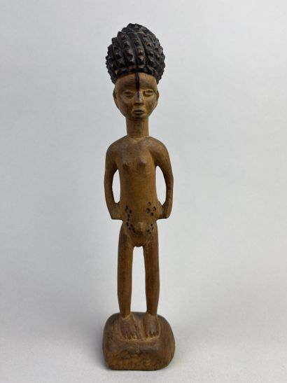 Statuette depicted standing on a round base,...
