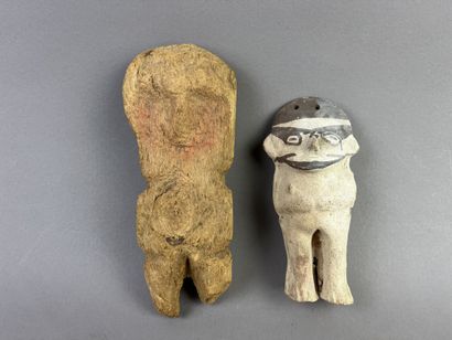 Two standing figures. One in beige and brown...