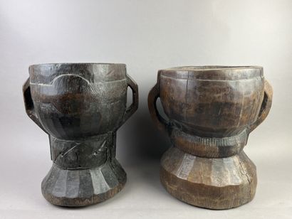 Two antique hourglass-shaped mortars decorated...