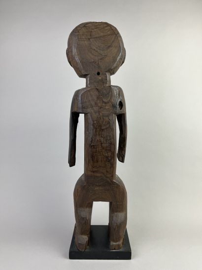 Male statue depicted standing with arms at...