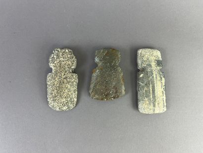 Three pendants depicting stylized figures....