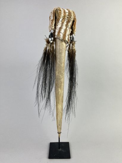Dagger adorned at the top with a fiber cap...