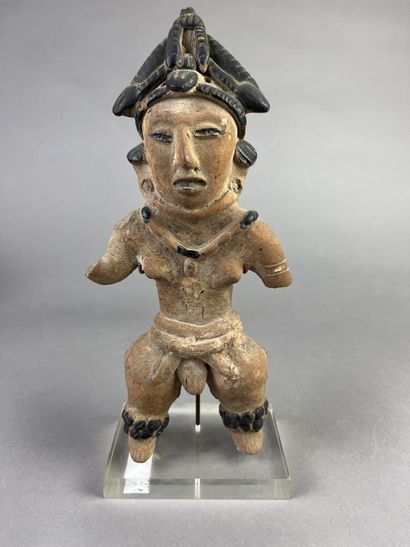 Standing female statuette wearing a cone-shaped...
