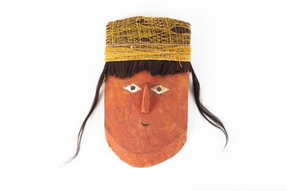 Funerary fardo mask. The rounded face features...