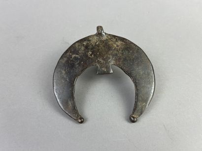 Crescent-shaped pendant with hornbill head....