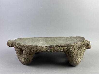 Metate. Corn grinding table. The top is supported...