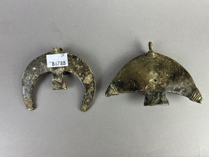 Two crescent-shaped pendants, each decorated...