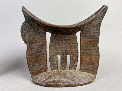 Two neck rests decorated with geometric motifs....