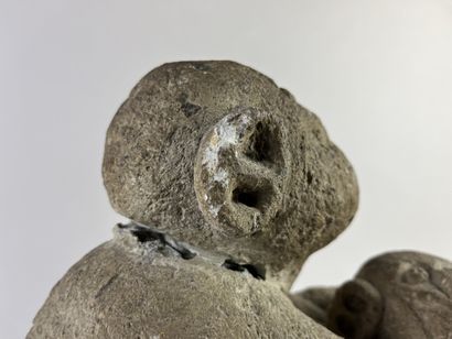 Sculpture depicting a simian figure holding...