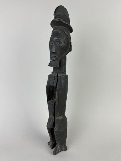 Standing fetish with scarified face, open...