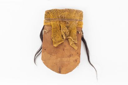 Funerary fardo mask. The rounded face features...