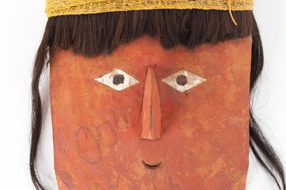 Funerary fardo mask. The rounded face features...