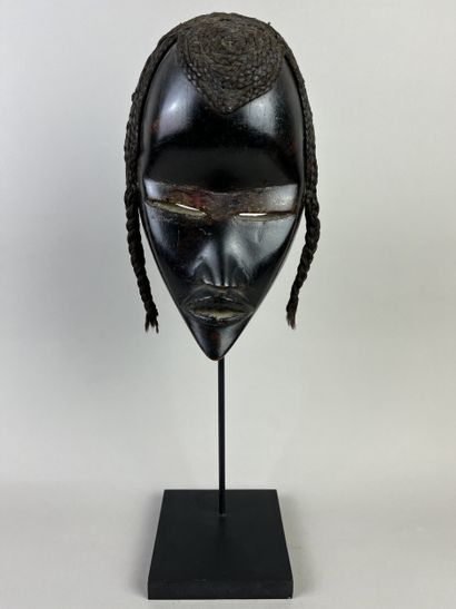 Mask with human face, a wolf painted black...
