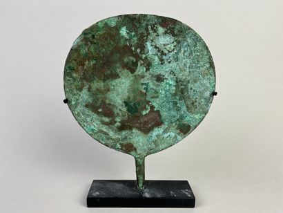 Mirror with a thin, round, slightly flattened...