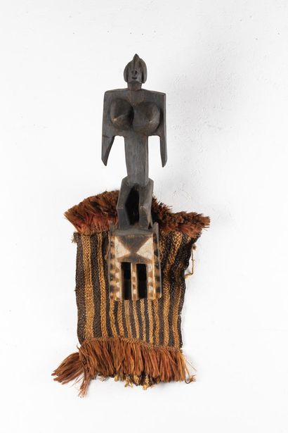Satimbe mask surmounted by a standing female...