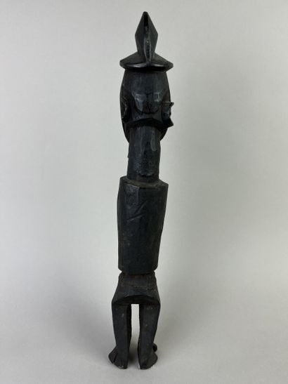 Standing fetish with scarified face, open...
