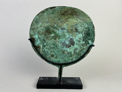 Mirror with a thin, round, slightly flattened...