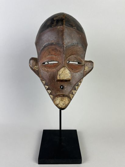Kindombolo mask. Mask with a human face adorned...