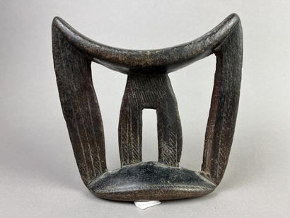 Two neck rests decorated with geometric motifs....