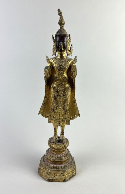 Buddha depicted standing on a pedestal, hands...
