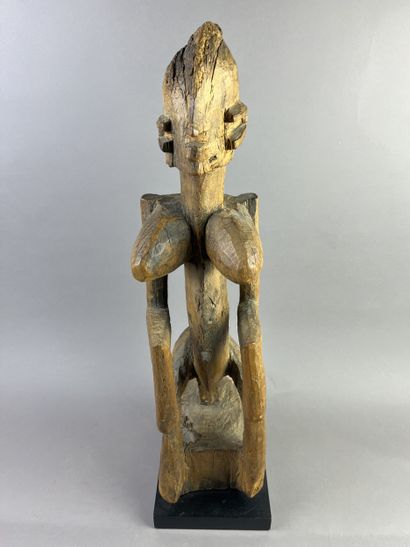 Cubist-style female statue, shown seated...
