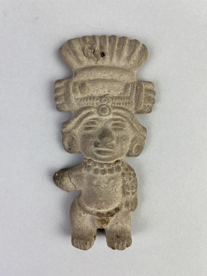 Statuette shown standing, wearing a large...
