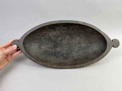 Food dish decorated with a rim incised with...
