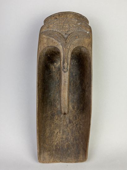 Pirogue scoop carved with a stylized human...