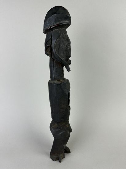 Standing fetish with scarified face, open...
