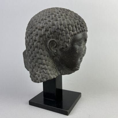 Female head wearing a curly wig. Hieroglyphic...