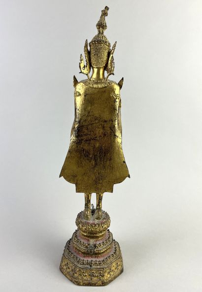 Buddha depicted standing on a pedestal, hands...