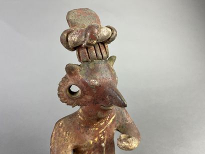 Seated figure, one knee on the ground, holding...