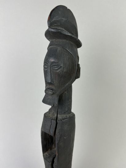 Standing fetish with scarified face, open...