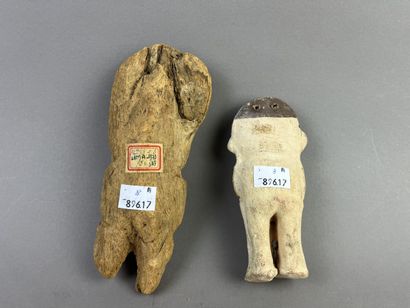 Two standing figures. One in beige and brown...