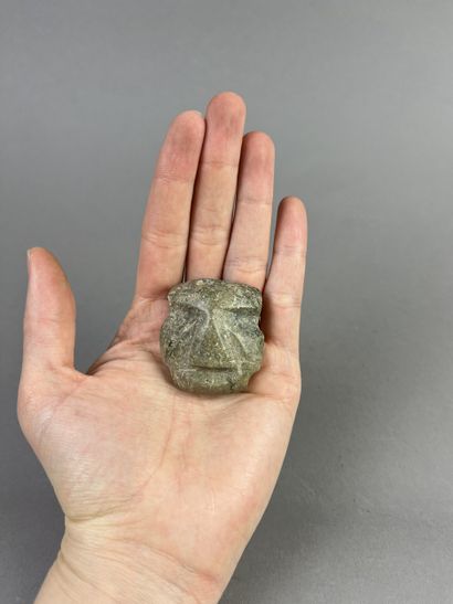 Pendant mask. The face is rectangular. Biconical...