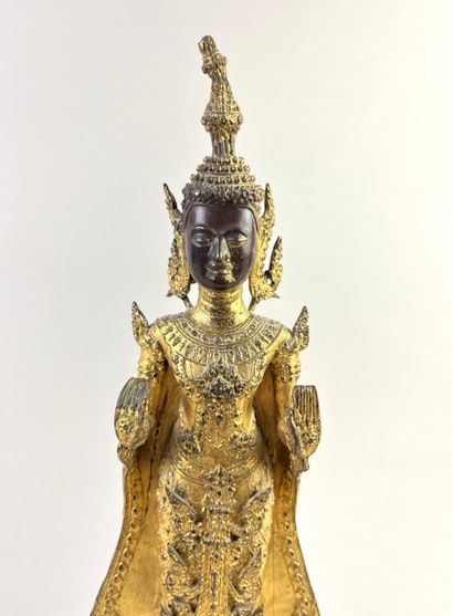 Buddha depicted standing on a pedestal, hands...