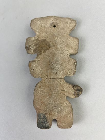Statuette shown standing, wearing a large...
