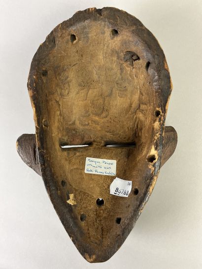 Kindombolo mask. Mask with a human face adorned...