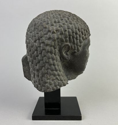 Female head wearing a curly wig. Hieroglyphic...