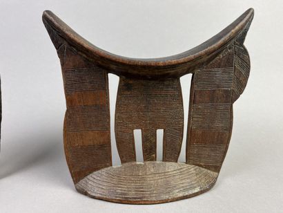 Two neck rests decorated with geometric motifs....