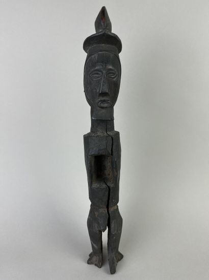 Standing fetish with scarified face, open...