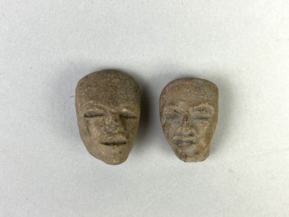 Two heads of statuettes. Beige terracotta....