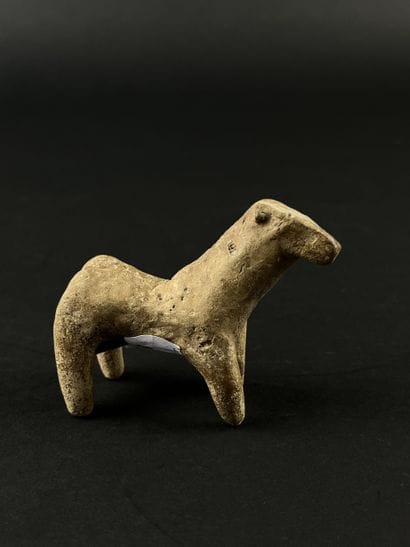 Statuette representing a stylized horse....