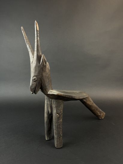 Tripod seat representing an antelope. Wood...