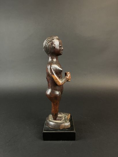 Standing mother with child on her left hip....