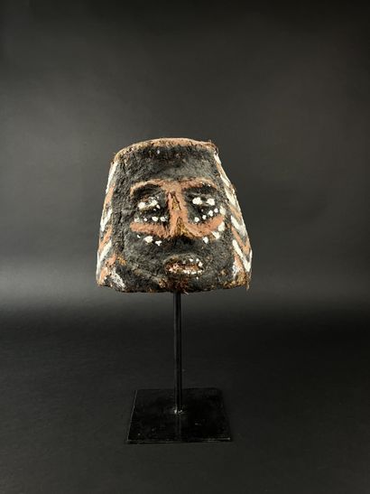 Janus helmet mask, depicting two human heads....