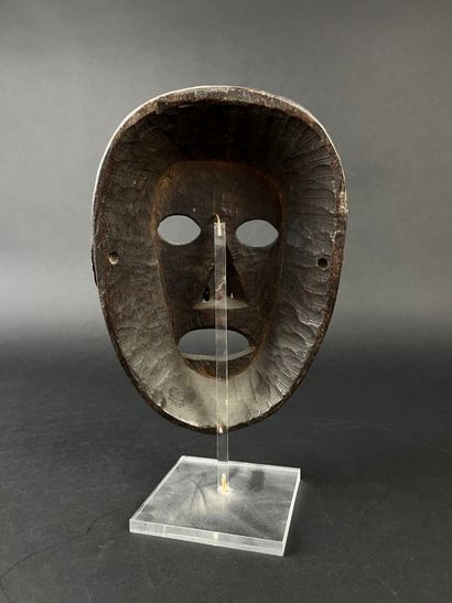 Shamanic mask with human face, oval shape,...
