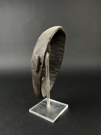 Shamanic mask with human face, oval shape,...