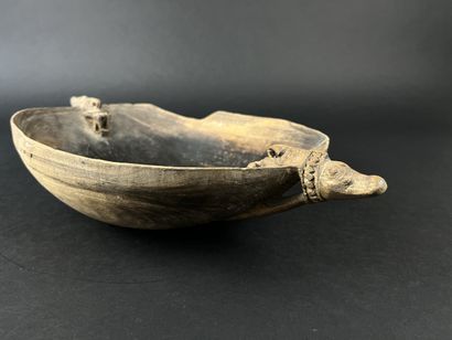 Wooden bowl decorated at the ends with two...